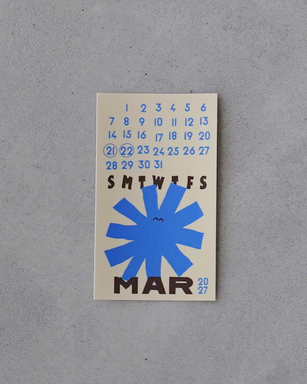 幻日堂の Morph Sticker Calendar モルフス sticker calendar の2027年1月〜12月分を描いたデザイン。青い花モチーフと日付が印刷された小型ステッカーが並ぶ前面ショット