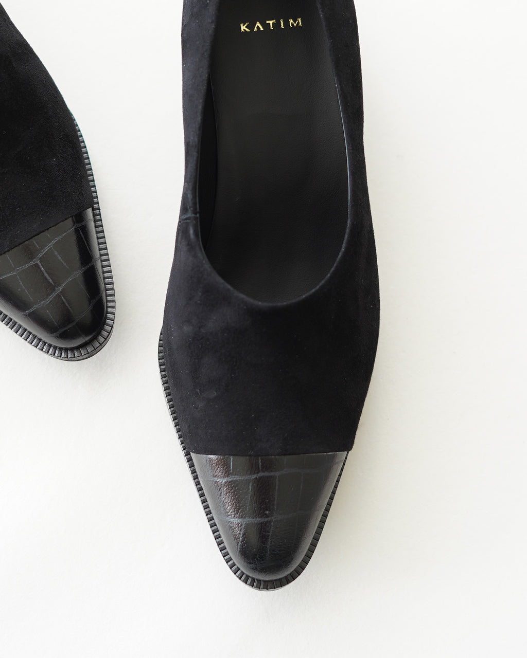 KATIMのブラック系パンプス。つま先はシャープなポインテッドトゥで、前方は黒のヌバック素材、つま先は艶やかなクロコ調の型押しパネルがアクセントになっています。