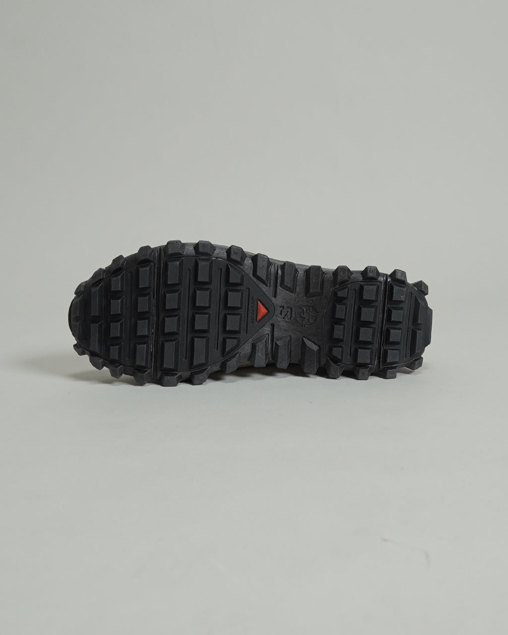 サロモン SNOWCLOG OG のアウトソール全体が見える磯陰の撮影。黒のラバーソールに凹凸のあるトレッドが特徴で、冬用スニーカーらしいタフな底構造が確認できる